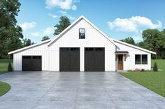 a white barn with two black garage doors