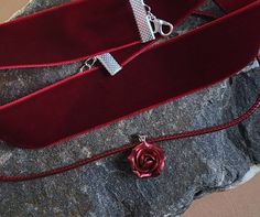 "Burgundy velvet choker - Ribbon choker necklace pendant - Polymer clay flower necklace Burgundy velvet ribbon choker with sculpted sparkly rose. Rose material is polymer clay with special strongcover. Each petal of flower made by hand without any mold Dia flower 13-15 mm/ 0.45-0.55 \" Length of necklace is adjustable:  10-12 inches/ 25,4 - 30,5 cm 11-13 inches/ 28-33 cm 12-14 inches/ 30.5- 35.5 cm 13-15 inches/ 33-38 cm 14-16 inches/ 35.5 cm-40.5 cm 15-17 inches/ 38,1 cm- 43,2 cm 16-18 inches/ Elegant Ribbon Choker As Gift, Adjustable Wedding Choker For Valentine's Day, Red Choker For Valentine's Day Gift, Valentine's Day Formal Choker Necklace, Elegant Red Choker For Gift, Elegant Red Choker As Gift, Elegant Red Choker For Valentine's Day, Elegant Choker Jewelry For Valentine's Day, Elegant Valentine's Day Jewelry Choker