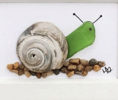 a painting of a snail with green shell and brown pebbles in front of white frame