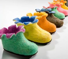 a row of colorful slippers with flowers on them