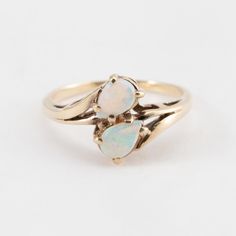 Hi. This is a pretty double opal ring, set in 10k yellow gold. It is marked 10, but faded, on the inside of the band. The opals are tear drop shaped. The ring finger size is 5.5. Sorry, we do not resize rings. The weight of the ring with the stones is 2 grams. Thanks for looking. 14k Gold Teardrop Ring, Gold Teardrop Opal Ring For Anniversary, 14k Gold Pear-shaped Opal Ring For Anniversary, Fine Jewelry Teardrop Opal Ring For Anniversary, Fine Jewelry Yellow Gold Pear-shaped Opal Ring, Yellow Gold Pear-shaped Opal Ring, Pear-shaped Yellow Gold Opal Ring, Fine Jewelry 14k Gold Pear-shaped Opal Ring, Teardrop Opal Promise Ring In Fine Jewelry Style