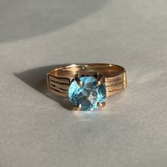 Vintage 18K (tested 17.26K) Gold Blue Topaz Solitaire Ring, Size 6, 2.2 grams, Engagement Ring or December Birth Ring Beautiful Blue Topaz ring - perfect Engagement Ring or gift. Size: 6 Weight: 2.2 grams Stones: Blue Topaz Color Stone: Blue Size Stone: ca. 8 mm dia. Number of Gemstones: 1 Cut: Round Marking: 18K Band Width: Band Material: Rose Gold Tested: Yes. Thermo Fisher Scientific DXL 800 Precious Metal Analyzer 17.26K (testing performed by 3rd party) Condition: Good preowned, usage and li Topaz Color, Perfect Engagement Ring, Blue Topaz Ring, Topaz Ring, 18k Rose Gold, Solitaire Ring, Precious Metals, Blue Topaz, Little Gifts