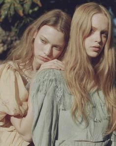 two beautiful young women standing next to each other