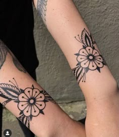 two people with matching tattoos on their arms