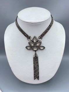 Vintage 1980's Erickson Beamon rhinestone 3 Chain necklace with large pendant and rhinestone tassels. 16" choker with a 2 1/2" wide pendant and 3 1/2" long tassels. Features marquise rhinestones surrounded by small rounds. Very good condition with original Japanning, which is a blackening technique and it looks like it effected some of the rhinestones in the small links. I have a collection of Beamon pieces from a Clients mother's estate. She shopped Paris and NYC in the 1980's and was quite wealthy and fashionable. I have not been able to find any of her collection of pieces online so I believe they are all one of a kind. Erickson Beamon is an iconic jewelry brand that stands out for its remarkable fusion of creativity and craftsmanship. Listing is cross posted!  Founded by Karen Erickson 3 Chain Necklace, Erickson Beamon, Vintage Designer Jewelry, Rhinestone Choker Necklace, Rhinestone Choker, Vintage Designer, Designer Jewelry, Choker, Choker Necklace