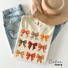 Welcome fall with our Coquette Fall Bow Shirt! Perfect for anyone who loves autumn, this charming design celebrates all things fall and Halloween. Whether you're out for a pumpkin patch visit or enjoying a crisp autumn day, this shirt will keep you stylish and festive all season long. #PumpkinSeason #FallFashion #AutumnVibes #CozyFall #SeasonalStyle #FallFun #Halloween Retro Fall Pumpkin Bow Shirt, Fall Coquette Bow Sweatshirt, Autumn Pumpkin Tee, Fall T-Shirt , Autumn Sublimation Design, Autumn White T-shirt For Fall Gift, White T-shirt As A Fall Gift, White T-shirt For Fall Season Gift, Fall Short Sleeve Tops For Gifts, Fall Short Sleeve Tops For Gift, Cotton Tops As Fall Gift, Short Sleeve Tops For Fall Gift, Cotton Top For Fall, Cute Fall T-shirt For Gift