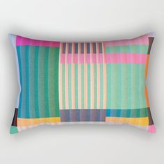 a rectangular pillow with multicolored stripes on it's front and back sides