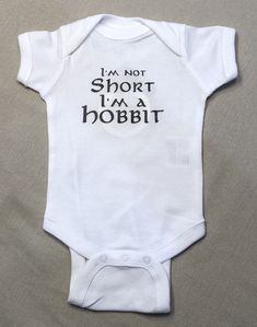 a white baby bodysuit that says i'm not short i'm a hobbit