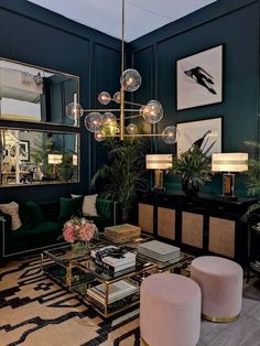 a living room filled with lots of green furniture and art on the wall above it