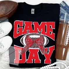 a football shirt with the words game day on it next to other sports equipment and items