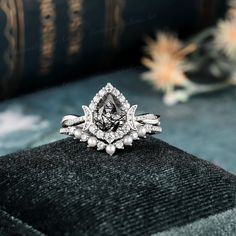 a diamond ring sitting on top of a velvet cushion