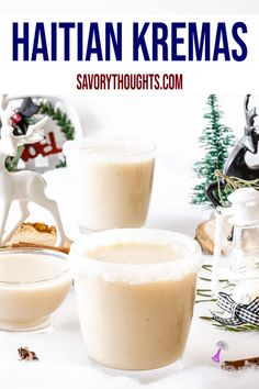 two glasses filled with pudding sitting on top of a table next to a christmas tree