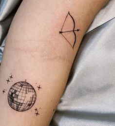 a person with a tattoo on their arm and an arrow in the middle of it