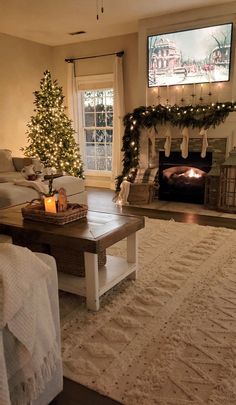 a living room filled with furniture and a christmas tree in front of a fire place