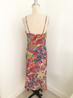 This is a midi dress by Eye Candy. The bright colored stylized paisley print makes this dress so much fun. Spaghetti straps, unlined. Perfect little number for any summer occasion. Made in USA, 100 percent polyester, Size tag L. Check measurements carefully, no stretch. Measurements taken with dress laying flat and doubled where appropriate. In order to determine fit we recommend comparing measurements with an item that fits you well. Length 46 inches Underarm to underarm 34 inches Waist 36 inch 80s Shorts, Vintage Slip Dress, Vintage Slip, Printed Robe, Vintage Slips, Vintage Cardigan, Spaghetti Strap Dress, Strap Dress, We Wear