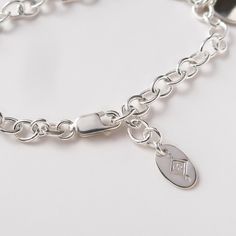 "Personalized Mother Bracelet in Sterling Silver A simple bracelet for mom personalized with kids' names. Substantial, modern and bold. Comfortable to wear. Layers beautifully with beaded or cuff bracelets. Makes a great gift for any mother or grandmother. You don't even have to know their exact wrist size since the length is adjustable - the clasp can close on any chain link! FEATURES: * your bracelet will be made to order with as many name charms as you need, * each name is hand stamped on a b Silver Name Bracelet, Mother Bracelet, Compass Necklace Silver, Bracelet For Mom, Mothers Bracelet, Compass Necklace, Kids Names, Simple Bracelets, Mom Jewelry