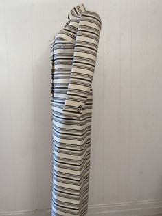 "Vintage 1960s maxi dress. Made of black and white striped wool. Mod op art design. The top three buttons and bottom three buttons are functional. Middle two buttons are decorative. One waist pocket. Dress is fully lined in white Rayon. No label. About a size medium. Measurements are: 35\" around the bust 32\" around the waist 37\" around the hips 15\" shoulder seam to shoulder seam 23\" shoulder seam to cuff 56.5\" overall length In very good condition." Retro Striped Dresses With Buttons, Striped Retro Dresses With Buttons, Striped Fitted Dress With Buttons, Fitted Striped Dresses With Buttons, Striped Fitted Dress With Button Closure, Fitted Striped Dress With Button Closure, Op Art Design, Vintage Dresses 1960s, 1960s Dress