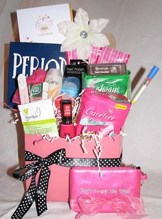 a pink gift bag filled with lots of goodies and personal care products on a table