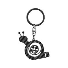 a black and white photo of a keychain that has a snail on it