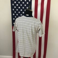 "Description: -In Semi-Distressed Shape Overall -Embroidered Design -Blue Striped Pattern Defects: Some Pilling along Collar. Several Holes on the Chest Graphic Area. Hole on Bottom Front of Tee. Staining across Shirt: --Bottom Front of Tee, --Armpit Areas, --Back Bottom, --and Back Side of Shirt. ID: 5D535 Measurements: L Chest (Across the Chest): 21\" Arm (Shoulder to Cuff): 8\" Overall (Front) Length: 25\"" Classic Navy T-shirt For Summer, Classic Striped Cotton T-shirt, Classic Striped Crew Neck T-shirt, Casual Crew Neck Shirt Made In Usa, Blue Short Sleeve T-shirt With American Flag Print, Blue Distressed Short Sleeve T-shirt, Blue Distressed Cotton T-shirt, American Style Blue Cotton T-shirt, Americana Cotton Tops Made In Usa