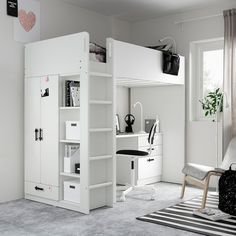 a loft bed with pink and white furniture in a child's playroom or bedroom