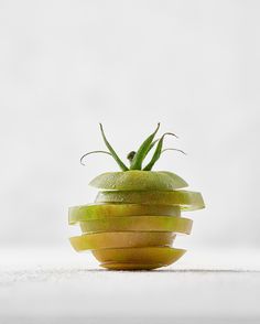 an apple sliced in half and stacked on top of each other