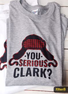 a t - shirt with the words you serious clark on it, and a red checkered hat