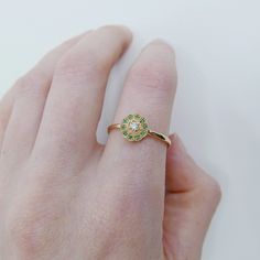 This "Flora" ring has a bit of old world charm to it, the pop of color from the emeralds surrounding the diamond really bring this ring to life. Like your very own bit on mother nature on your finger. This Flora ring is also a great addition to your everyday ring collection, and can be stacked to perfection! Details: 14k Gold (options to choose from: yellow, rose or white) Available in sapphire, ruby, emerald, or diamond options. This ring can come in a half diamond pave band upon request (pleas