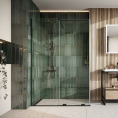 a bathroom with a walk in shower next to a sink and a mirror on the wall