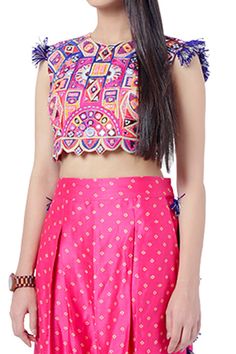 Hot pink crop top with embroidery and tassels. Comes with bandhani print low crotch pants.
Component: 2
Pattern: Embroidery and Print
Type Of Work: Thread and Bandhani Print
Neckline: Round
Sleeve Type: Sleeveless
Fabric: Georgette and Silk
Color: Pink
Other Details: 
Pants with tassel detail at the sides
Side pockets
Scalloped hem
Closure: Hook back
Note: Sling bag carried by the model is not for sale
Occasion: Destination Wedding - Aza Fashions Crop Top With Pants, Low Crotch Pants, Top With Pants, Bandhani Print, Payal Singhal, Pink Thread, Embroidery Print, Embroidered Crop Tops, Pattern Embroidery