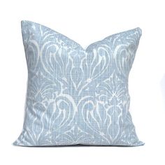 a blue and white pillow sitting on top of a table