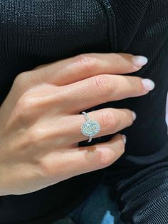 a woman's hand with a diamond ring on it