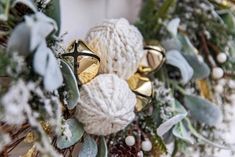 a christmas wreath with bells and greenery