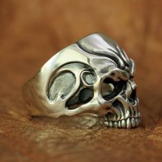 Edgy Silver Rings For Streetwear, Edgy Silver Skull Ring As Gift, Edgy Silver Skull Ring For Gift, Adjustable Silver Skull Ring Punk Style, Adjustable Silver Skull Ring In Punk Style, Silver Edgy Skull Ring For Halloween, Silver Skull Ring For Biker Events And Halloween, Silver Skull Ring For Halloween, Edgy Silver Skull Ring For Halloween