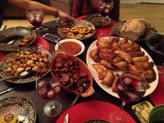 a table filled with food and wine glasses