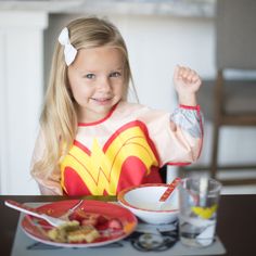 The Wonder Woman Sleeved Bib saves one outfit at a time. With a handy crumb catcher / catch-all pocket for containing spills. Generously sized and made from Bumkins lightweight, waterproof, easy-wipe, stain and odor resistant fabric. Single ply construction means no worrying about icky stuff growing between layers of fabric. Without a cotton layer, stains and smells don't stick. Adjust the fit with a back-tie closure and adjust sleeve length with elasticized cuffs. Bib For Baby, Dc Comic Costumes, Woman Costume, Wonder Woman Costume, Cutest Thing Ever, Women Sleeve, Women's Costumes, Burp Cloths, Waterproof Fabric