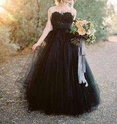 a woman in a black dress holding a bouquet