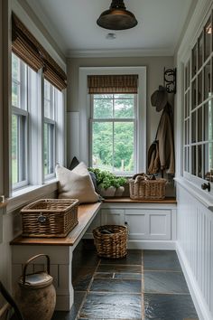 a window seat with baskets on it in front of a window and some windowsills