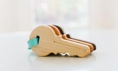 a wooden toy with a blue ribbon on it