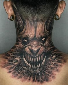 the back of a man's neck with tattoos on it