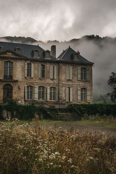 an old house in the middle of a field