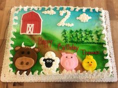 a sheet cake decorated with farm animals and sheep