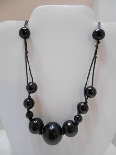 "Vintage black plastic beaded necklace. 28\" long. Spring fastener. Rope style chain. Pretty! Excellent condition. Unsigned." Black Beaded Long Necklace With Round Beads, Black Beaded Necklace With Round Beads, Polished Black Beads For Long Necklace, Black Polished Long Necklace Beads, Black Long Necklace With Round Beads, Black Round Bead Costume Necklaces, Black Round Beads Costume Necklace, Black Beaded Chain Long Necklace, Black Round Beads Costume Jewelry Necklace