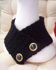 two stuffed animals sitting next to each other on a white chair with black and red buttons