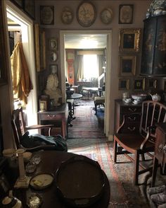 a living room filled with furniture and lots of clocks