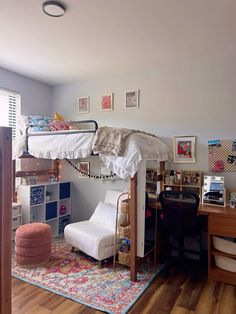 a loft bed is in the corner of this room with a desk and chair underneath it