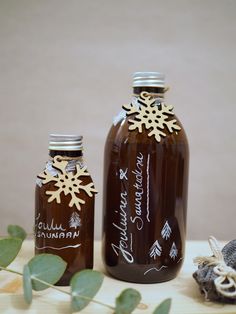 two bottles filled with liquid sitting on top of a table