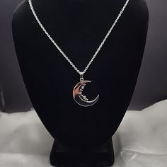 Beautiful Moon With Stars And Cz's Stainless Steel Pendant Necklace Material: Stainless Steel,Cz's Color: Silver Cz Color:Clear Thickness: 0.08" (2mm) Pendant Approximate Width: 1.06" (27mm) Length: 1.46" (37mm) Includes:18" Stainless Steel Cable Chain Hypoallergenic Great Gift & Nice Look Silver Moon Shaped Diamond Jewelry, Silver Cubic Zirconia Charm Necklaces For Jewelry Making, Silver Crescent Jewelry With Cubic Zirconia, Stainless Steel Rhinestone Jewelry As Gift, Silver Crescent Cubic Zirconia Jewelry, Silver Diamond Jewelry With Moon Charm, Stainless Steel Rhinestone Jewelry Gift, Celestial Style Silver Stainless Steel Necklace, Silver Moon-shaped Diamond Jewelry