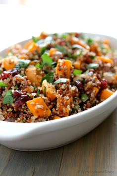 a white bowl filled with food on top of a wooden table