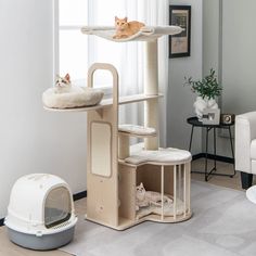 two cats are laying on top of the cat tree in this living room with white furniture